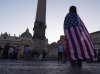 Andrea Gallardo, 20, from Texas, wears an American flag after Pope Leo XIV appeared on the balcony of St Peter's Basilica following his election, at the Vatican, Thursday, May 8, 2025. (AP Photo/Paolo Santalucia)