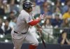 Boston Red Sox's Rafael Devers watches his two-RBI single during the fourth inning of a baseball game against the Milwaukee Brewers, Wednesday, May 28, 2025, in Milwaukee. (AP Photo/Jeffrey Phelps)