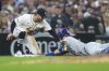 Chicago Cubs' Ian Happ (8) slides safely into third base under the tag of Detroit Tigers third baseman Zach McKinstry in the eighth inning during a baseball game, Friday, June 6, 2025, in Detroit. (AP Photo/Paul Sancya)