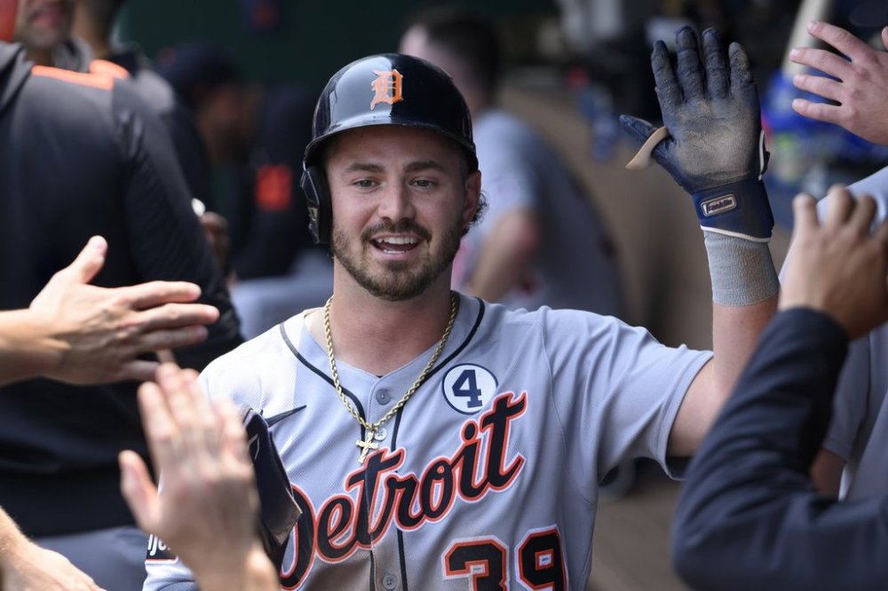 Detroit Tigers' Zach McKinstry is congratulated after scoring on a wild pitch during the third inning of a baseball game against the Kansas City Royals in Kansas City, Mo., Sunday, June 1, 2025. (AP Photo/Reed Hoffmann)