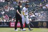 Athletics' Shea Langeliers, right, leaves the game and walks back to the dugout with a trainer after taking a swing and grabbing his side during the sixth inning of a baseball game against the Minnesota Twins Thursday, June 5, 2025, in West Sacramento, Calif. (AP Photo/Scott Marshall)