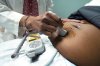 A doctor uses a hand-held Doppler probe on a pregnant woman to measure the heartbeat of the fetus, Dec. 17, 2021, in Jackson, Miss. THE CANADIAN PRESS/AP-Rogelio V. Solis