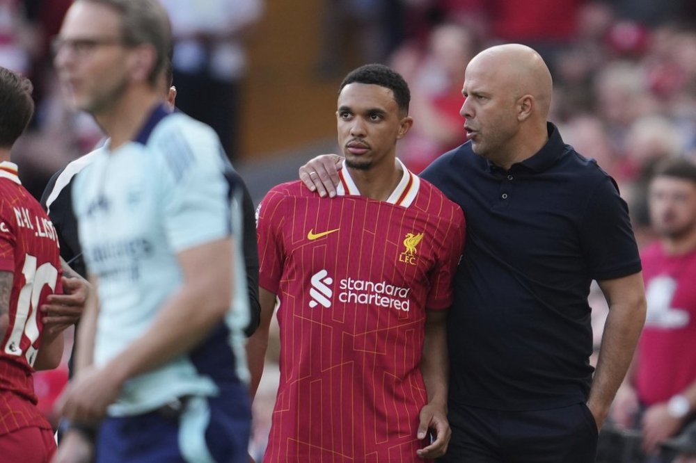 Liverpool's manager Arne Slot, right, gives instructions to Liverpool's Trent Alexander-Arnold during the English Premier League soccer match between Liverpool and Arsenal, at Anfield stadium in Liverpool, England, Sunday, May 11, 2025. (AP Photo/Jon Super)