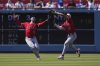 Los Angeles Angels' Kyren Paris, right makes a catch on a ball hit by Los Angeles Dodgers' Mookie Betts as Taylor Ward collides with him during the seventh inning of a baseball game Sunday, May 18, 2025, in Los Angeles. (AP Photo/Mark J. Terrill)