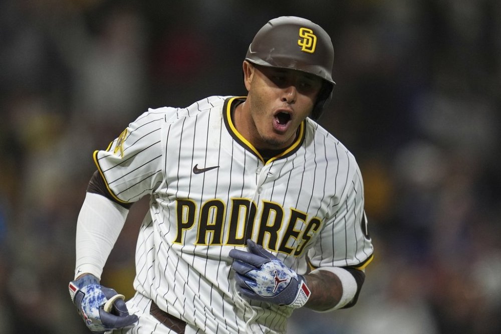 San Diego Padres' Manny Machado celebrates after hitting a home run during the fifth inning of a baseball game against the Chicago Cubs Tuesday, April 15, 2025, in San Diego. (AP Photo/Gregory Bull)