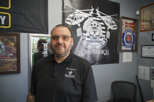Ralph Rodriguez poses for a portrait at his pawn and gun shop in Fayetteville, N.C., Friday, May 9, 2025. (AP Photo/Allen G. Breed)