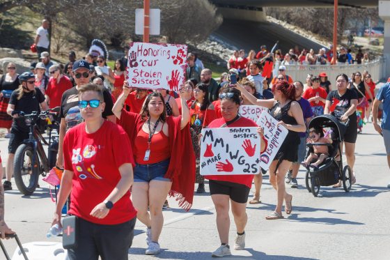 Drumming and singing, dressed in red and carrying signs and banners, people walked to The Forks and made their way to the Oodena Circle in commemoration of Red Dress Day. (Mike Deal / Free Press files)