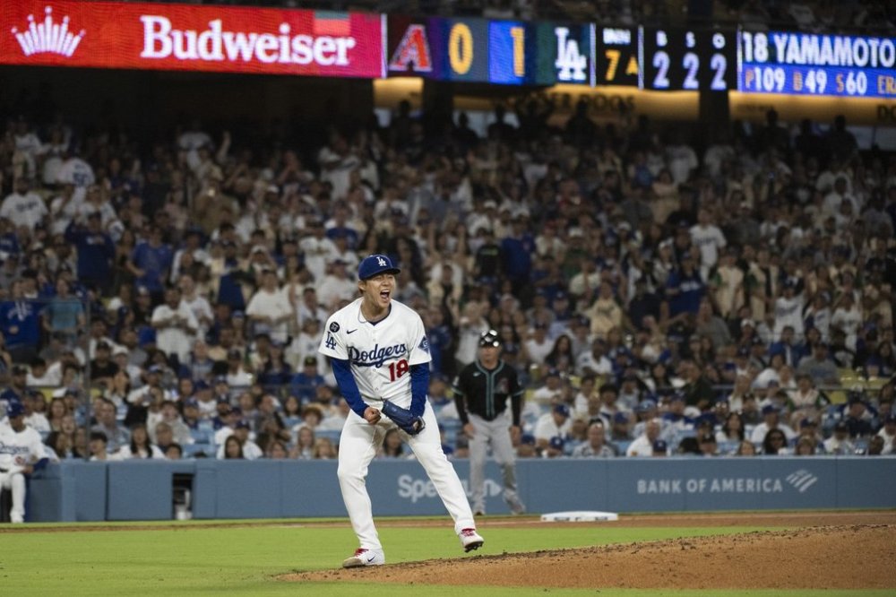 Los Angeles Dodgers starting pitcher Yoshinobu Yamamoto reacts after striking out Arizona Diamondbacks' Pavin Smith during the seventh inning of a baseball game in Los Angeles, Tuesday, May 20, 2025. (AP Photo/Kyusung Gong)