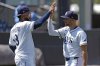 Tampa Bay Rays' Junior Caminero (13) and Brandon Lowe celebrate after the team defeated the Minnesota Twins during a baseball game Wednesday, May 28, 2025, in Tampa, Fla. (AP Photo/Chris O'Meara)