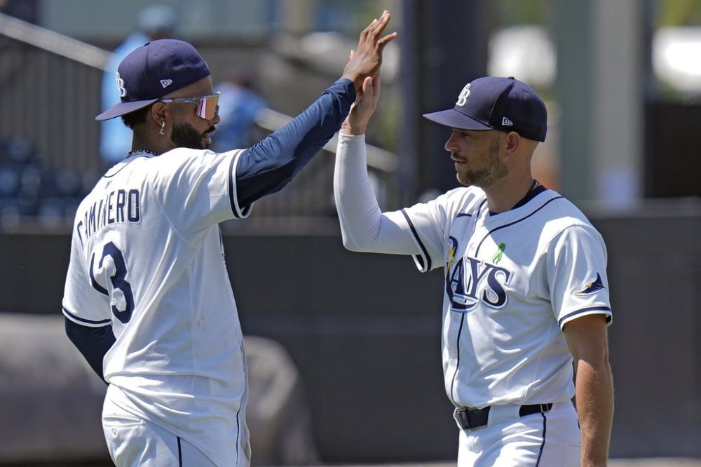 Tampa Bay Rays' Junior Caminero (13) and Brandon Lowe celebrate after the team defeated the Minnesota Twins during a baseball game Wednesday, May 28, 2025, in Tampa, Fla. (AP Photo/Chris O'Meara)