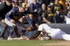 Pittsburgh Pirates' Oneil Cruz, right, slides safely into third base with an RBI triple as Milwaukee Brewers third baseman Caleb Durbin, left, apples a late tag during the seventh inning of a baseball game Saturday, May 24, 2025, in Pittsburgh. (AP Photo/Matt Freed)
