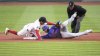 Boston Red Sox second baseman David Hamilton, left, tags out New York Mets' Pete Alonso, center, who was trying to advance to second on his single during the first inning of a baseball game at Fenway Park, Monday, May 19, 2025, in Boston. (AP Photo/Charles Krupa)
