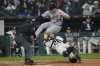 Detroit Tigers designated hitter Colt Keith (33) jumps over Chicago White Sox catcher Korey Lee (26) but is tagged out at home during the eighth inning of a baseball game Wednesday, June 4, 2025, in Chicago. (AP Photo/Erin Hooley)