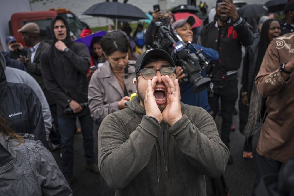 FILE - A protestor shouts,