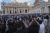 Faithful take photos the black smoke billows from the Sistine Chapel during the conclave to elect a new Pope, at the Vatican, Thursday, May 8, 2025 (AP Photo/Emilio Morenatti)