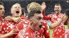Mainz's Paul Nebel, foreground, celebrates the goal by Jonathan Burkhardt, during the German Bundesliga soccer match between FSV Mainz 05 and Eintracht Frankfurt, at Mewa Arena, in Mainz, Germany, Sunday, May 4, 2025. (Torsten Silz/dpa via AP)