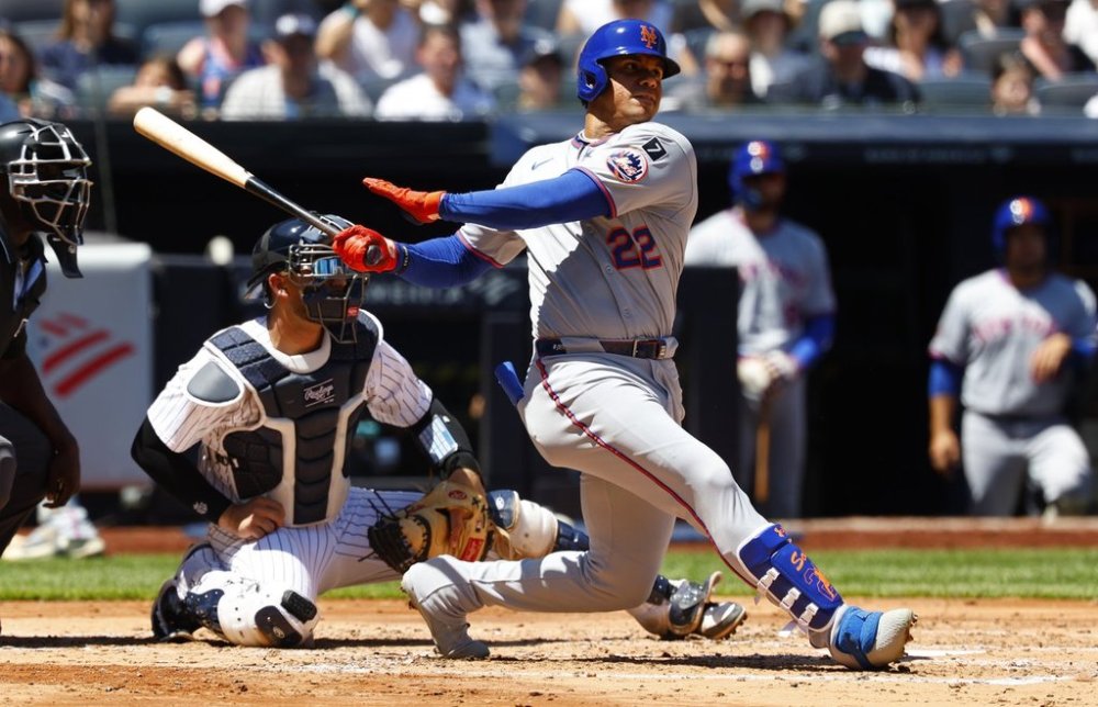 New York Mets' Juan Soto (22) hits a a single against the New York Yankees during the fourth inning of a baseball game, Saturday, May 17, 2025, in New York. (AP Photo/Noah K. Murray)