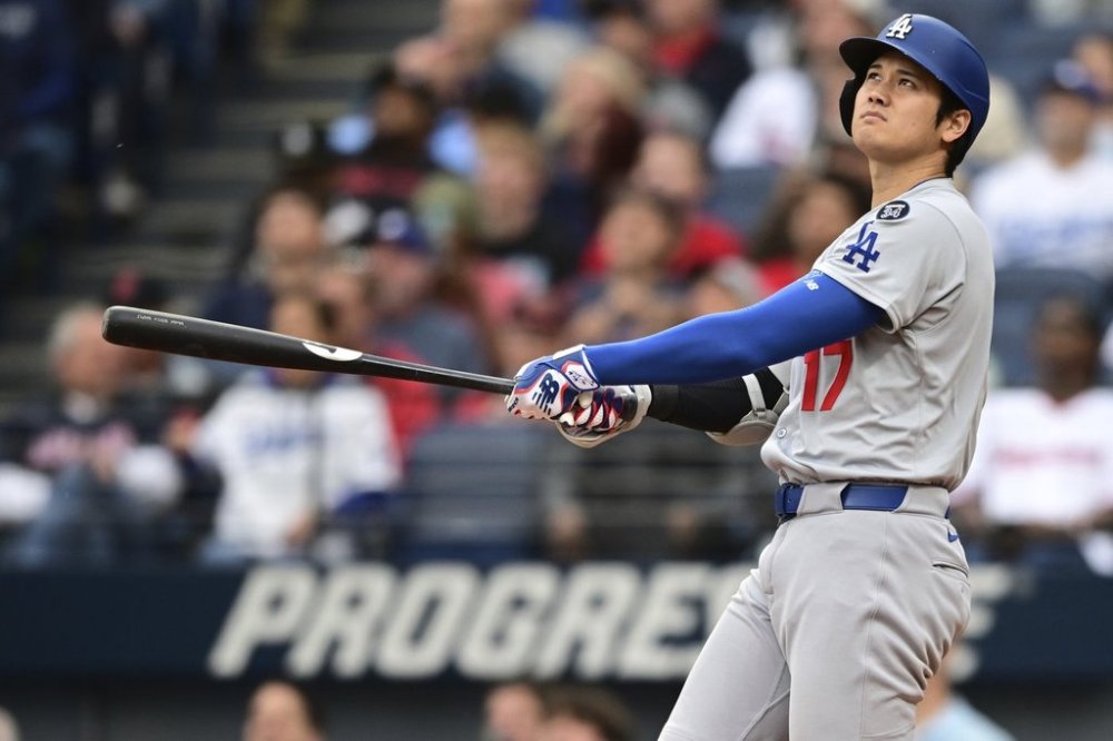 Los Angeles Dodgers' Shohei Ohtani watches his ball after hitting a two run home run off Cleveland Guardians starting pitcher Tanner Bibee during the fourth inning of a baseball game, Tuesday, May 27, 2025, in Cleveland. (AP Photo/David Dermer)