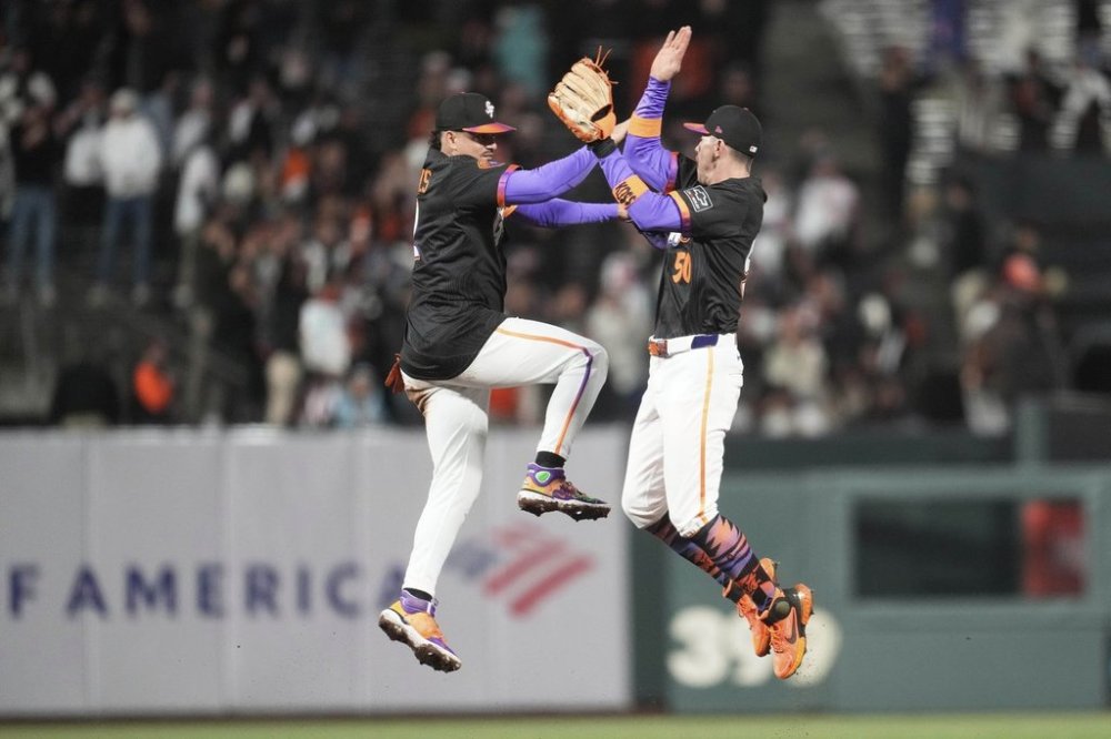 San Francisco Giants shortstop Willy Adames, left, and second baseman Christian Koss celebrate after a baseball game against the Arizona Diamondbacks in San Francisco, Tuesday, May 13, 2025. (AP Photo/Jeff Chiu)