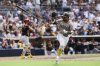 San Diego Padres' Luis Arraez tosses his bat after hitting an RBI single against the Pittsburgh Pirates in the seventh inning of a baseball game Sunday, June 1, 2025, in San Diego. (AP Photo/Derrick Tuskan)