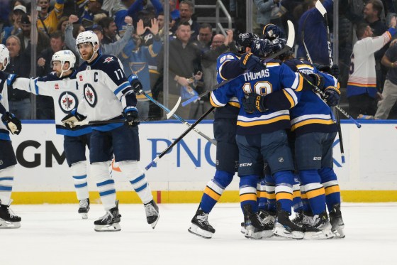 Winnipeg Jets center Adam Lowry (17) looks on as the St. Louis Blues celebrate after a first-period goal by Philip Broberg in Game 6 on Friday. (Jeff Le / The Associated Press files)