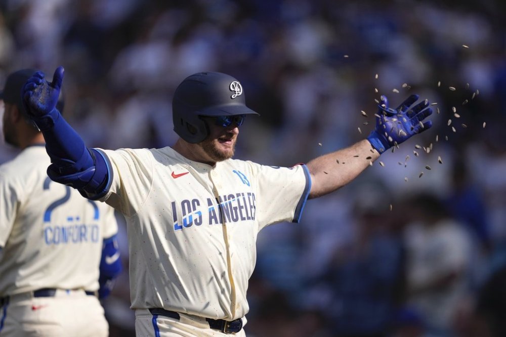 Los Angeles Dodgers' Max Muncy has seeds thrown at him after hitting a three-run home run during the second inning of a baseball game against the New York Yankees, Saturday, May 31, 2025, in Los Angeles. (AP Photo/Mark J. Terrill)