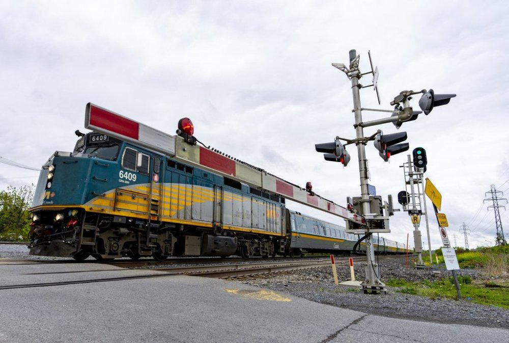 A Via Rail train is seen on tracks in the Montreal suburb of Beaconsfield as it heads out of the city on May 23, 2025. THE CANADIAN PRESS/Christinne Muschi