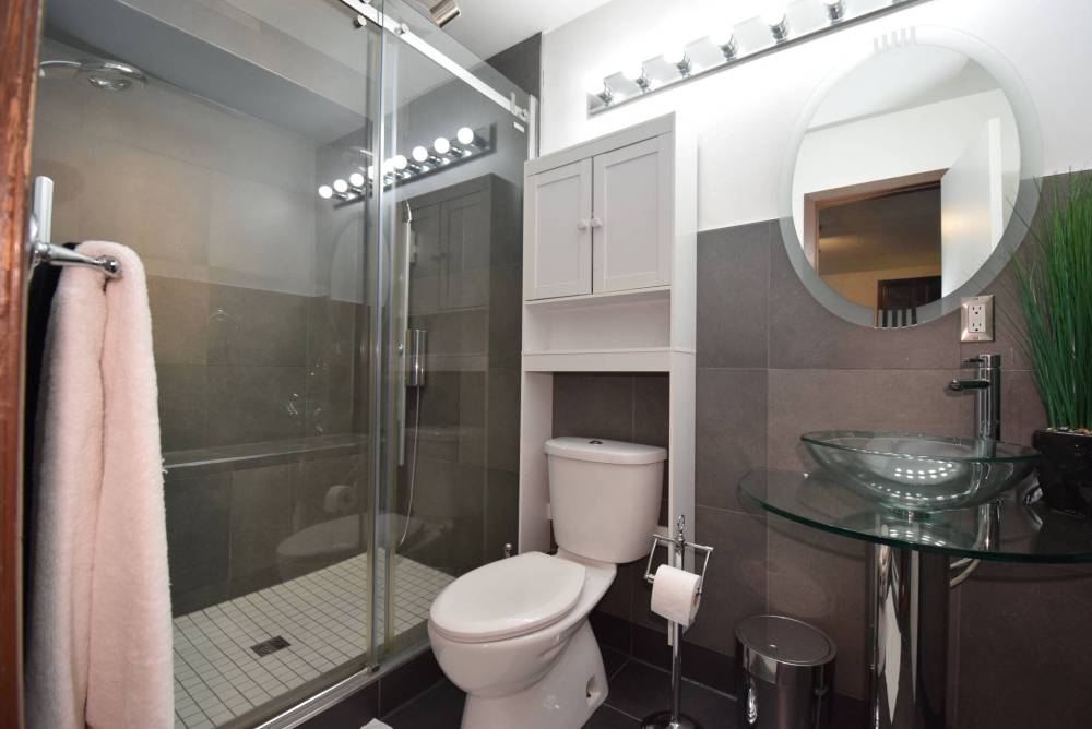 Todd Lewys / Free Press
Anchored by a gorgeous walk-in shower with sliding tempered-glass doors and two-tone tile surround, the main bathroom is a luxurious, spa-like space.