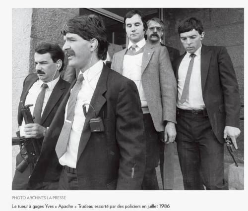 La Presse
                                In this 1986 photo, Yves Trudeau (centre) is escorted by heavily armed police officers as he leaves the courthouse after testifying against his fellow bikers. This is the last known photo of Trudeau.