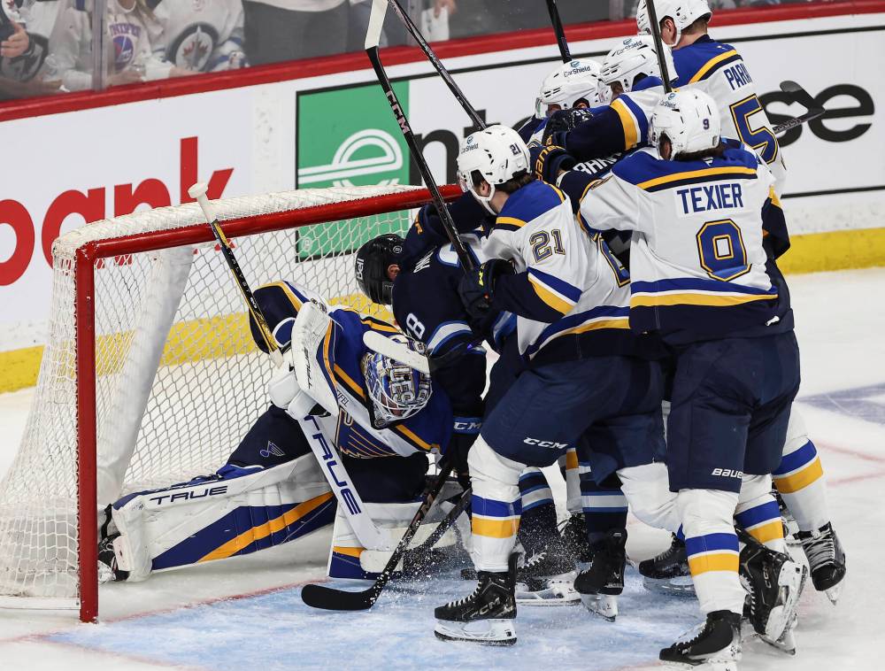St. Louis Blues goaltender Jordan Binnington (50) saves the shot from Winnipeg Jets’ Jaret Anderson-Dolan (28) during first period NHL playoff action in Winnipeg on Wednesday. (John Woods / The Canadian Press)