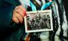 Sean Kilpatrick / The Canadian Press via AP
                                Canadian Holocaust survivor Miriam Ziegler holds up a photo of her (circled) as she attends the Commemoration Ceremony of the 80th Anniversary of the Liberation of Auschwitz, in Oswiecim, Poland, on Jan. 27.