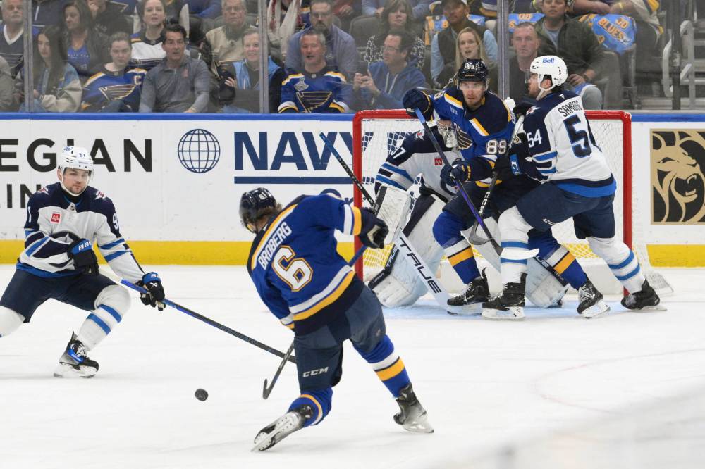 St. Louis Blues left wing Pavel Buchnevich (89) battles Winnipeg Jets defenseman Dylan Samberg (54) in front of Jets goaltender Connor Hellebuyck Friday. (Jeff Le / The Asscoiated Press)