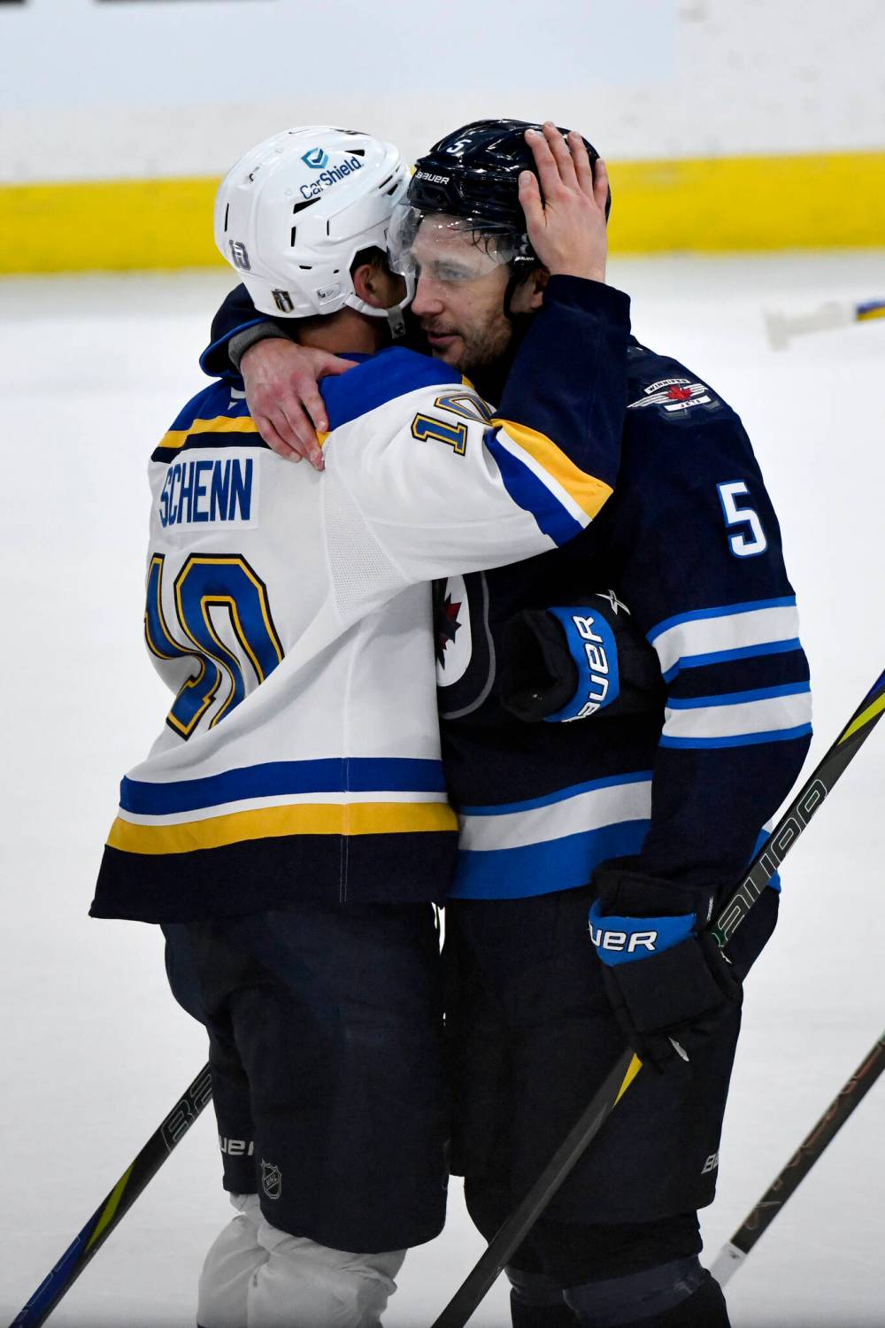 St. Louis Blues’ Brayden Schenn (10) shakes hands and hugs his brother Winnipeg Jets’ Luke Schenn (5) at the end of the game. (Fred Greenslade / The Canadian Press)