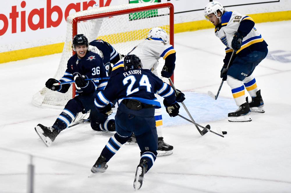Winnipeg Jets’ Morgan Barron (36) and Haydn Fleury (24) defend against St. Louis Blues’ Cam Fowler (17) and Robert Thomas (18) in front of goaltender Connor Hellebuyck (37) during the second period. (Fred Greenslade / The Canadian Press)