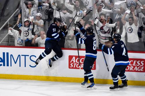 Fred Greenslade / THE CANADIAN PRESS
                                Winnipeg Jets&rsquo; Neal Pionk (right) celebrates Cole Perfetti&rsquo;s (left) game-tying goal with less than three seconds remaining in regulation Sunday night in Winnipeg.