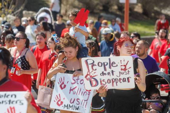 Hundreds of people walked from Memorial Park to The Forks during the annual Red Dress Day memorial walk, Monday morning in Winnipeg. (Mike Deal / Free Press)