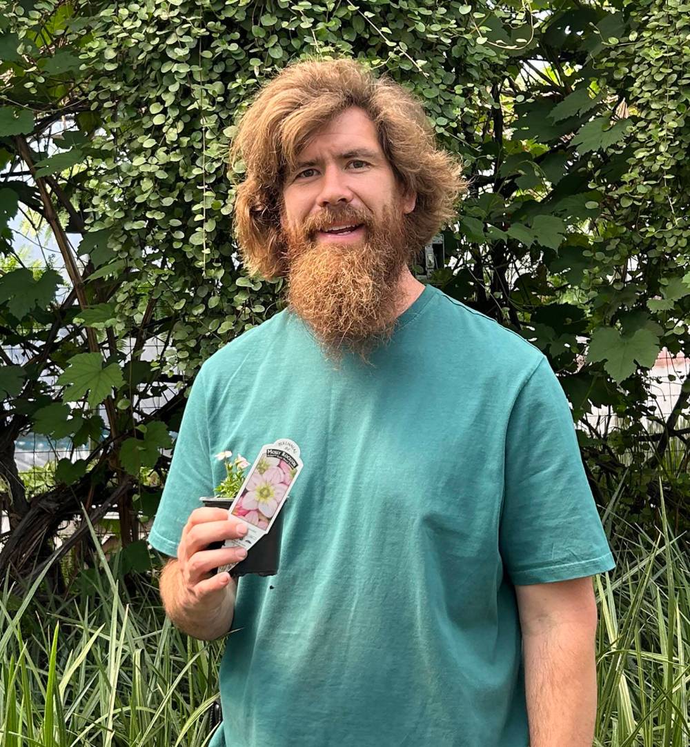 COLLEEN ZACHARIAS / FREE PRESS
                                Shea Doherty, operations manager at Our Farm Greenhouse near Portage la Prairie, holds one of his many new plant varieties for this year.