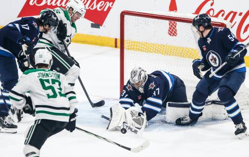 JOHN WOODS / THE CANADIAN PRESS FILES
                                Winnipeg Jets goaltender Connor Hellebuyck (37) saves a shot against the Dallas Stars when the two teams met in March at Canada Life Centre.
