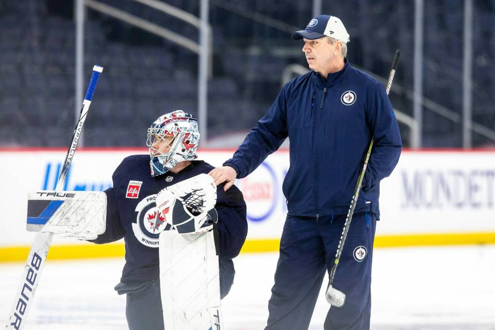 MIKAELA MACKENZIE / FREE PRESS
Winnipeg Jets backup goalie Eric Comrie (left) works with goalie coach Wade Flaherty at Canada Life Centre. Comrie says Flaherty “doesn’t try to change your game, he tries to add to your game.”