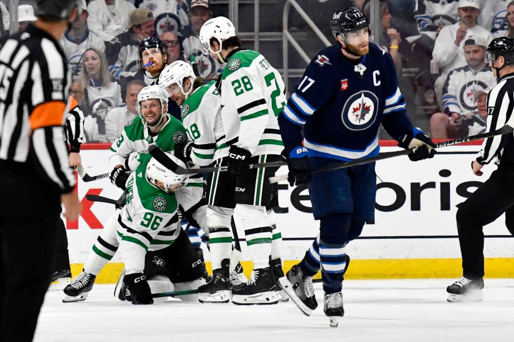 Dallas Stars’ Mikko Rantanen (96) is helped up by teammates after scoring on the Winnipeg Jets during second period NHL playoff hockey action in Winnipeg, Wednesday. (Fred Greenslade / The Canadian Press)