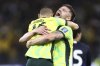 Australia's Cameron Burgess, right, and Aziz Behich celebrate after defeating Japan in their World Cup 2026 group C qualifying soccer match in Perth, Thursday, June 5, 2025. (AP Photo/Trevor Collens)