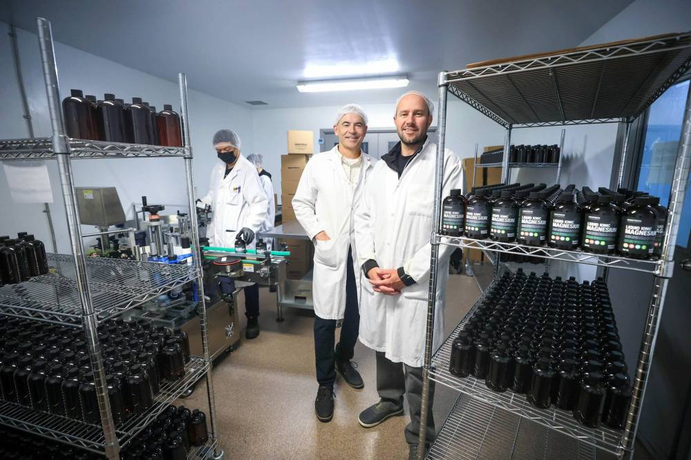 Innotech Nutrition co-owner Wayne Friesen (left) and general manager Adam Fries in one of its production rooms. ‘We don’t have any sugar on the premises,’ Friesen says. (Ruth Bonneville / Free Press)