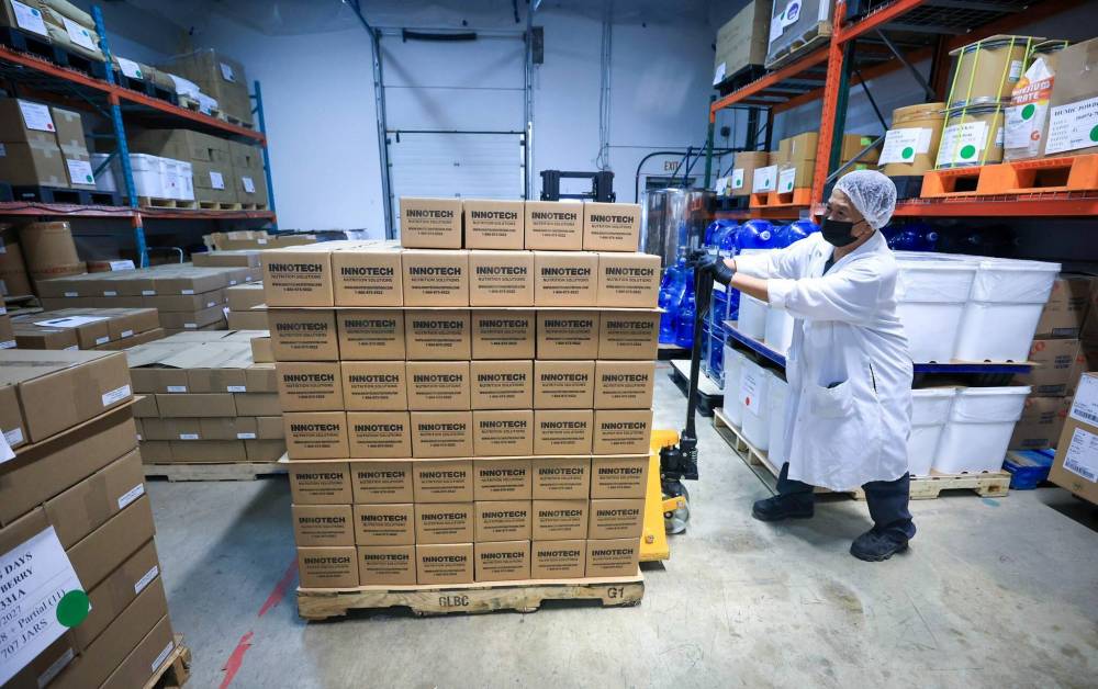 Innotech Nutrition shipping employee Rudy moves a pallet of packaged products. (Ruth Bonneville / Free Press)