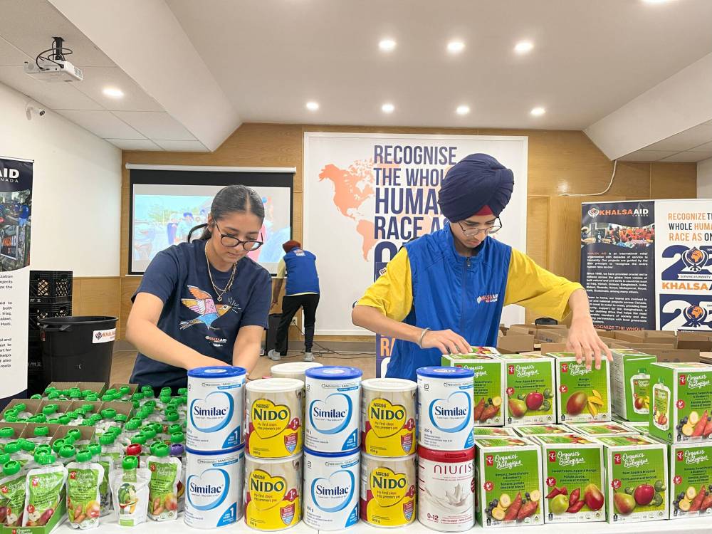 MALAK ABAS /FREE PRESS
Khalsa Aid Manitoba volunteers Gurneet, 16, and Harjas, 15, stock baby formula, the most-requested item at Saturday’s food drive.