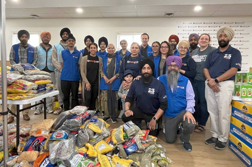 MALAK ABAS /FREE PRESS
Volunteers at Khalsa Aid Manitoba’s food drive Saturday post in front of piles of food donated by the Sikh community.