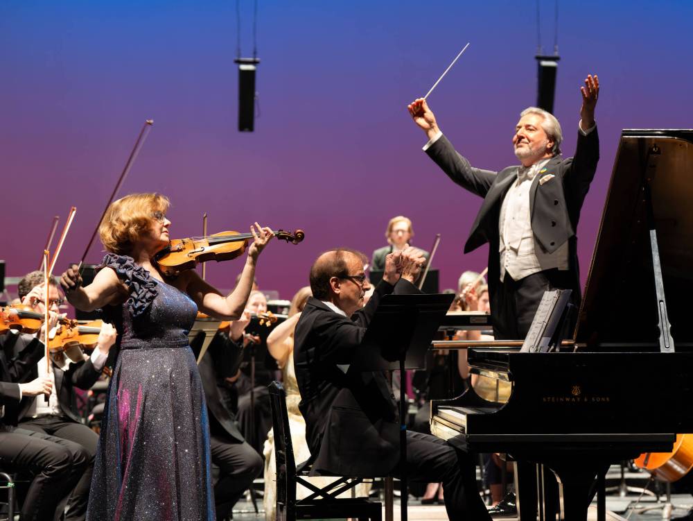 Mark Rash photo
Maestro Daniel Raiskin (right) leads the orchestra, violinist Gwen Hoebig and her pianist husband David Moroz on Mozart’s Concerto for Violin, Piano and Orchestra.