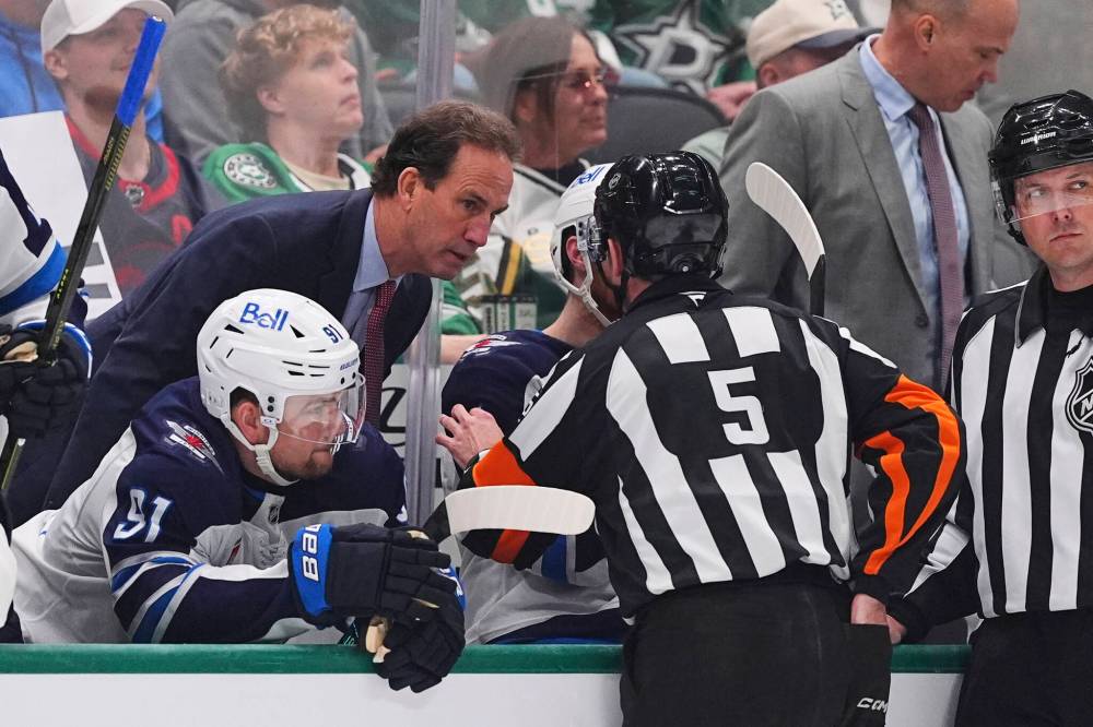 Julio Cortez / The Associated Press
Winnipeg Jets head coach Scott Arniel, left, talks with referee Chris Rooney after a controversial goal in the third period.