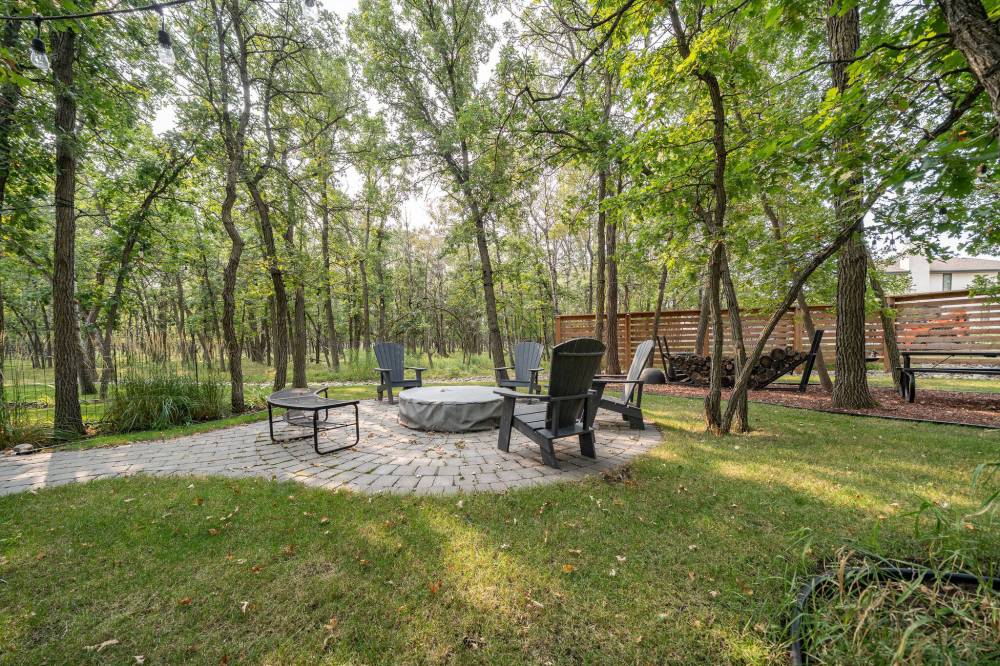 TODD LEWYS / FREE PRESS
A lock-stone pathway leads to a firepit area in the home’s private, treed backyard.