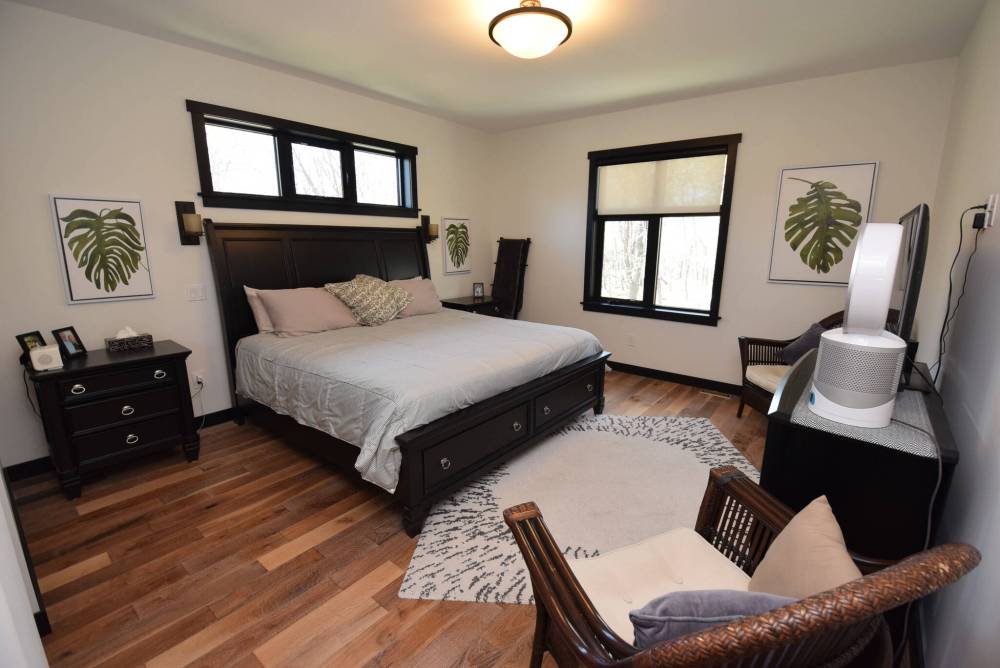 TODD LEWYS / FREE PRESS
Nestled neatly behind the great room, the primary bedroom is a private retreat.