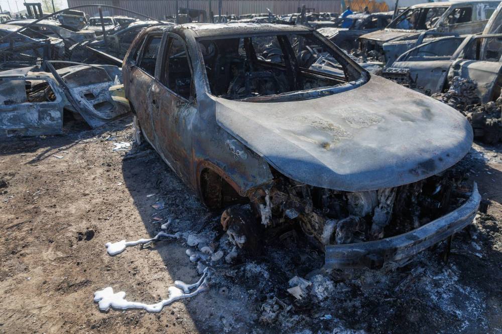 MIKE DEAL / FREE PRESS
                                A bright rivulet of aluminium that was once a tire rim stretches out from a burnt car. Hundreds of burnt out cars sit in a lot at 568 Gunn Road, destroyed by a grassfire.